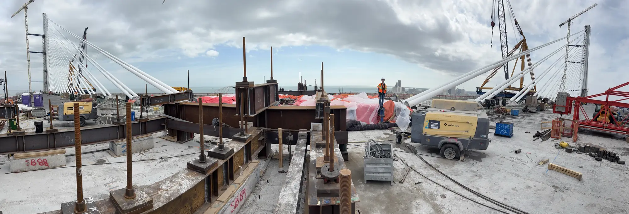 Panorama from the Harbor Bridge deck: white stay-cable pipes and steel anchor beams.